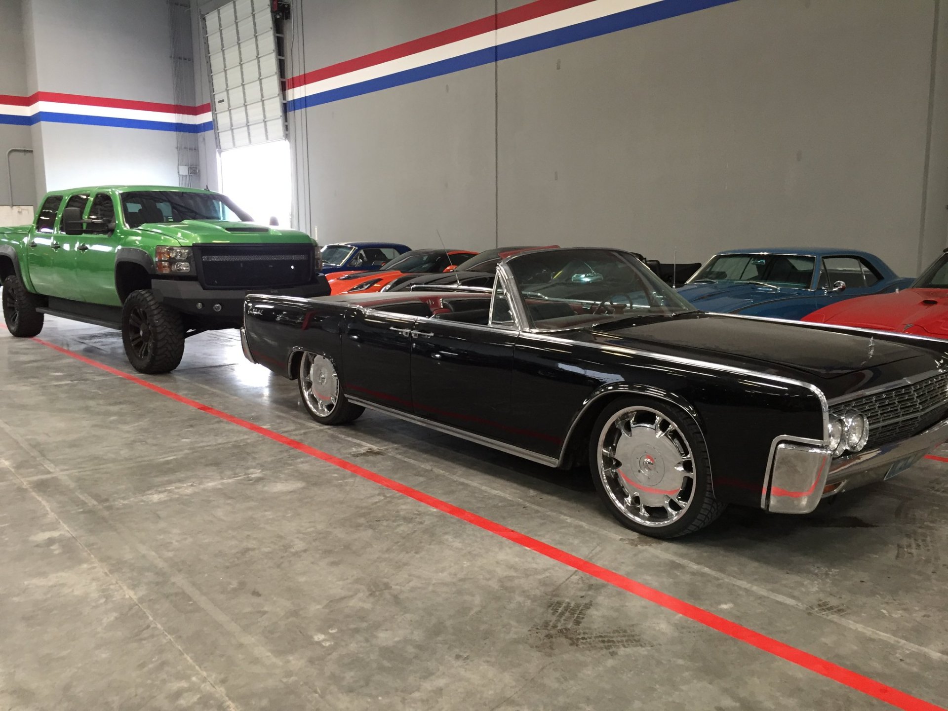 Lifted truck and classic Lincoln Continental in indoor Vegas storage